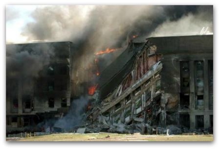 The Pentagon in flames on September 11, 2001, after terrorists flew hijacked American Airlines Flight 77 into the side of the building.