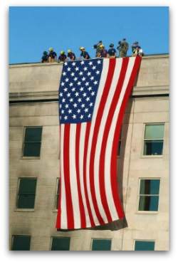 A huge American flag is draped over the side of the damaged Pentagon after the terrorist attacks of September 11, as a symbol, to both Americans and the terrorists, of American pride, strength, and determination.