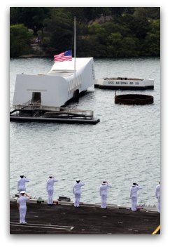 Sailors and officers render honors as their ship passes the USS Arizona Memorial in Pearl Harbor, Hawaii.